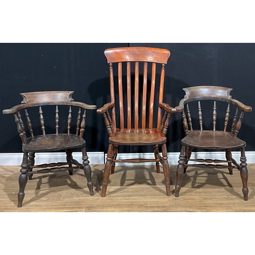 379 - A Victorian smoker’s bow elbow chair; another, similar; a similar lath-back armchair (3)