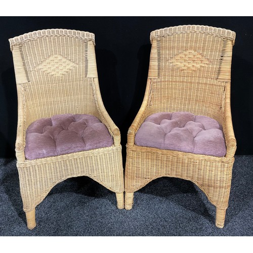 409 - A pair of cane conservatory chairs, with upholstered seats