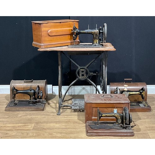 411 - A Bradbury Rotary Shuttle treadle sewing machine; others, table-top, Singer (4)