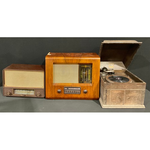 599 - An HMV oak table top wind-up gramophone, model 109; a Bush radio, Type PB.12; a Sobell bakelite radi... 