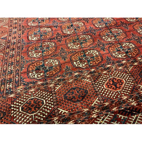 130 - A Turkman Bokhara rug, hand-knotted, typical repeating geometric design, in red with black, orange, ... 