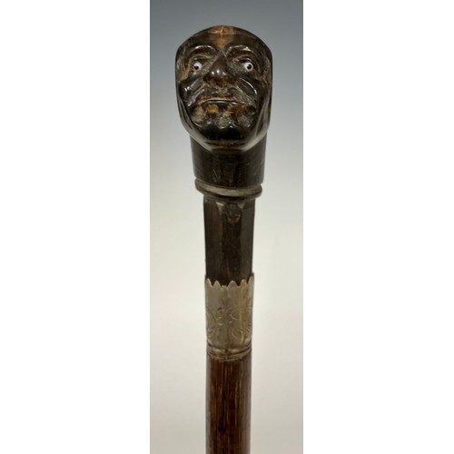 156 - A carved horn handled walking stick, as a bald mans head, inset glass eyes, metal ferule, banded tap... 