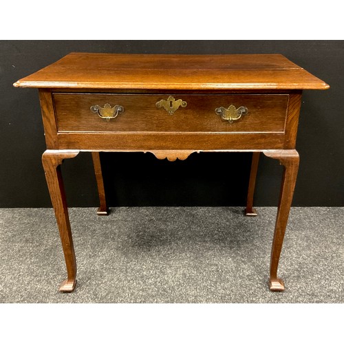 251 - A George III oak lowboy, the over-sailing rounded rectangular top, above a single long cock-beaded d... 