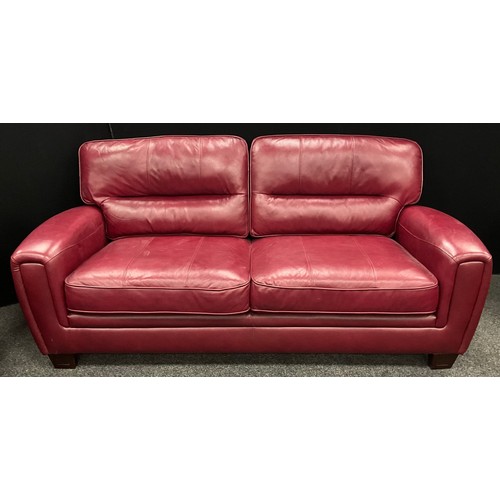 255 - An ‘Italia Lucca’ type model red leather three seat sofa, and matching pair of armchairs - the sofa ... 