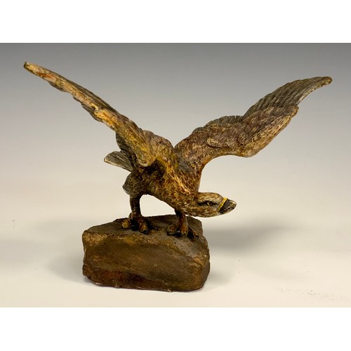 325 - An Austrian cold painted bronze, of an eagle, perched on a rock with wings outstretched, 19cm wide