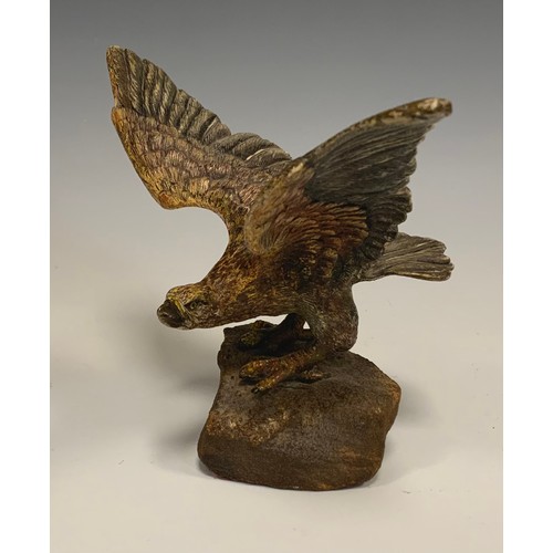 325 - An Austrian cold painted bronze, of an eagle, perched on a rock with wings outstretched, 19cm wide