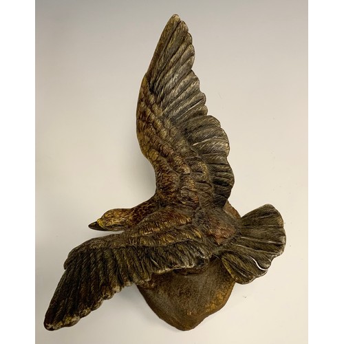 325 - An Austrian cold painted bronze, of an eagle, perched on a rock with wings outstretched, 19cm wide