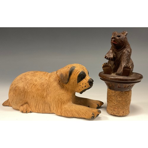 326 - A 19th century Black Forest bear bottle topper, marked Grindelwald;  a recumbent dog (2)