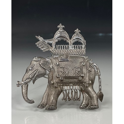 439 - An Indian silver elephant procession brooch, modelled with double canopy, trailing coat and flags, u... 