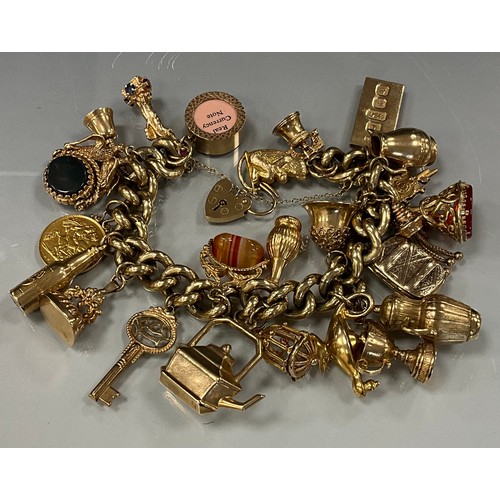 466 - A good heavy weight 9ct gold charm bracelet with twenty two charm, including seal stamps, Monkey, Al... 