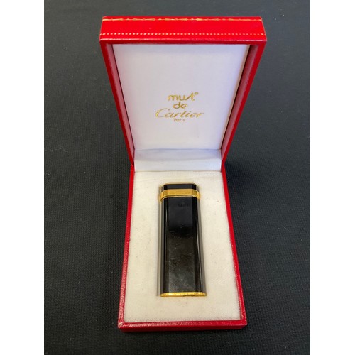 492 - Cartier - a gold plated and black pocket lighter, signed, serial number 00713T, marked Plaque or G, ... 