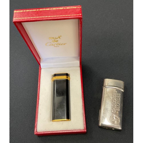 492 - Cartier - a gold plated and black pocket lighter, signed, serial number 00713T, marked Plaque or G, ... 