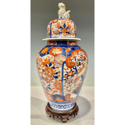 29 - A Japanese Meiji Imari vase and cover, on hardwood stand