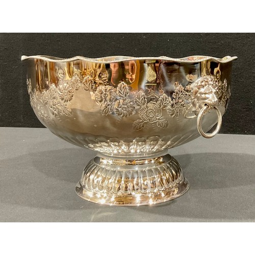 44 - A large silver plated pedestal punch bowl, embossed with foliate scrolls, pair of lion mask loop han... 