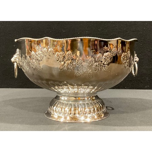 44 - A large silver plated pedestal punch bowl, embossed with foliate scrolls, pair of lion mask loop han... 