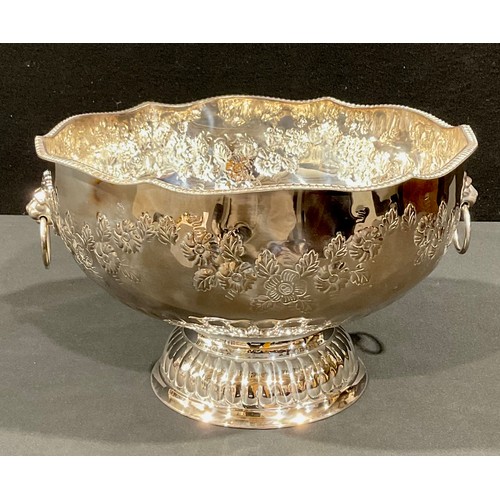 44 - A large silver plated pedestal punch bowl, embossed with foliate scrolls, pair of lion mask loop han... 