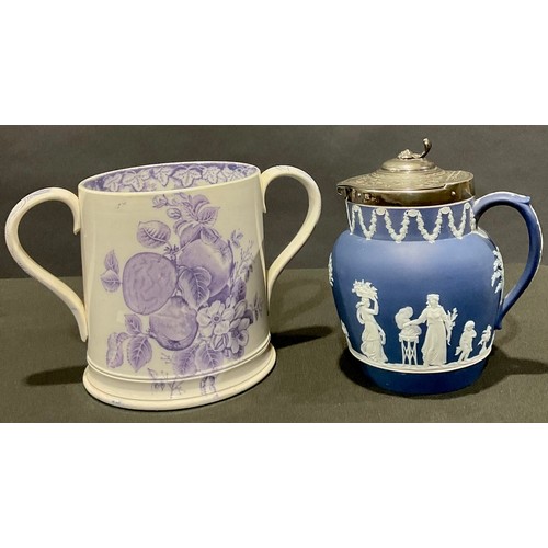 72 - A large Staffordshire two-handled loving mug, transfer printed in lilac with fruit and flowers, the ... 