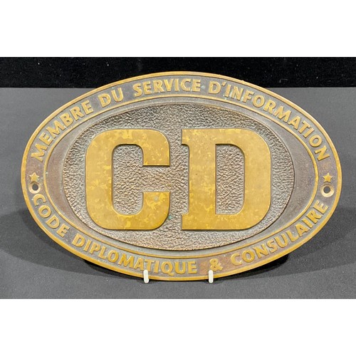 75 - An oval bronze plaque, CD, Membre Du Service D'Information Code Diplomatique & Consulaire, 29cm wide