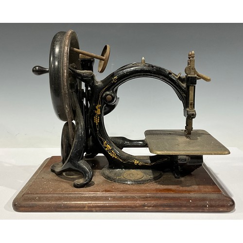 41 - A late 19th century Willcox & Gibbs C-frame hand-cranked sewing machine, mahogany rounded rectangula... 