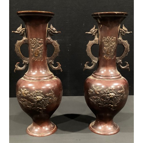 87 - A pair of Japanese bronze vases, cast in relief with flowers and birds, dragon scroll handles, 40cm ... 