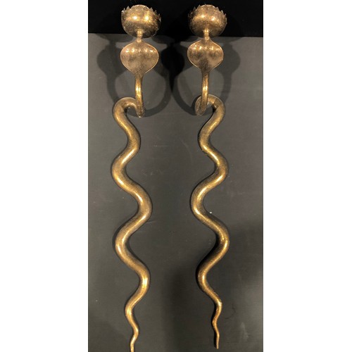 99 - A pair of Indian brass candle wall sconces, each modelled as a cobra, chased throughout scrolling fo... 