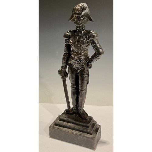 123 - A cast iron doorstop, Lord Nelson, in feathered hat with sword by his side, stepped base, 39cm