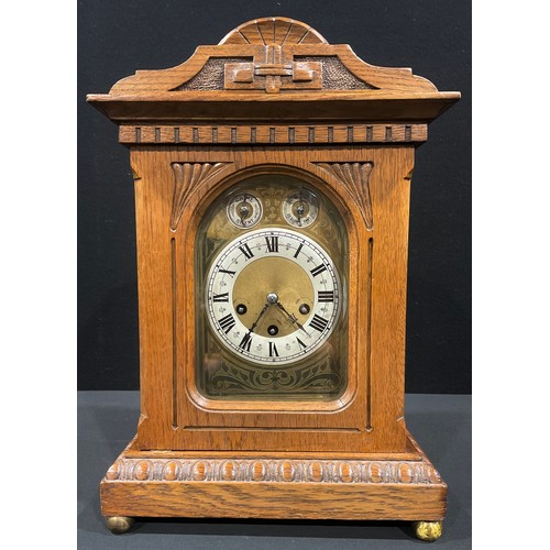 128 - An Edwardian light oak mantel clock, arched case, silvered chapter ring with Roman numerals, pair of... 