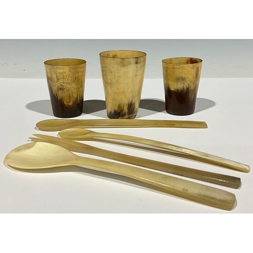 148 - Three horn beakers; horn spoons and fork