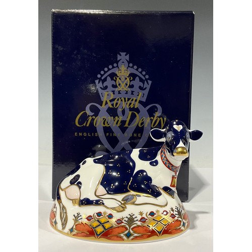 1 - A Royal Crown Derby paperweight, Friesian Cow 'Buttercup', gold stopper, red printed marks and Royal... 