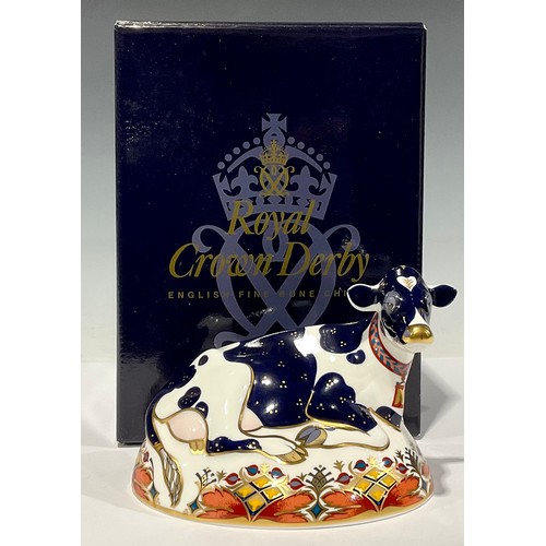 1 - A Royal Crown Derby paperweight, Friesian Cow 'Buttercup', gold stopper, red printed marks and Royal... 