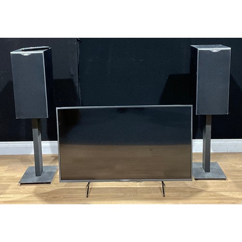 487 - A pair of Bowers & Wilkins speakers, model DM602S2, on stands; a Sony 43