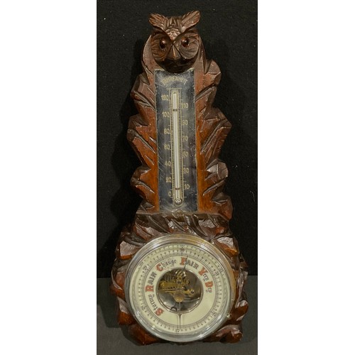 510 - An black forest aneroid barometer, carved as an owl, glass eyes