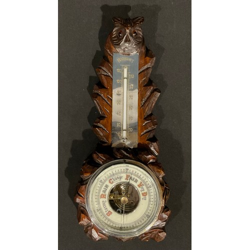 510 - An black forest aneroid barometer, carved as an owl, glass eyes