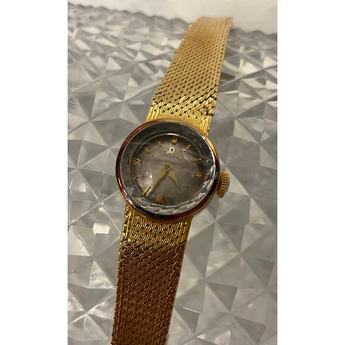 1014 - Omega - a late 1950s lady's 18ct gold cased bracelet wristwatch, faceted glass edged crystal, silver... 