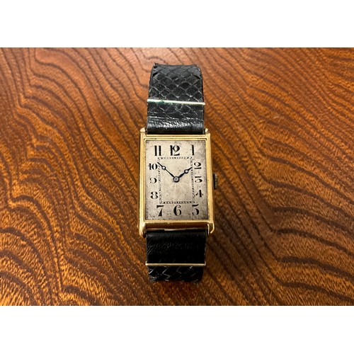 1045 - A 1920s gold cased wristwatch, rectangular silver dial, Arabic numerals, inner minute track, blued h... 