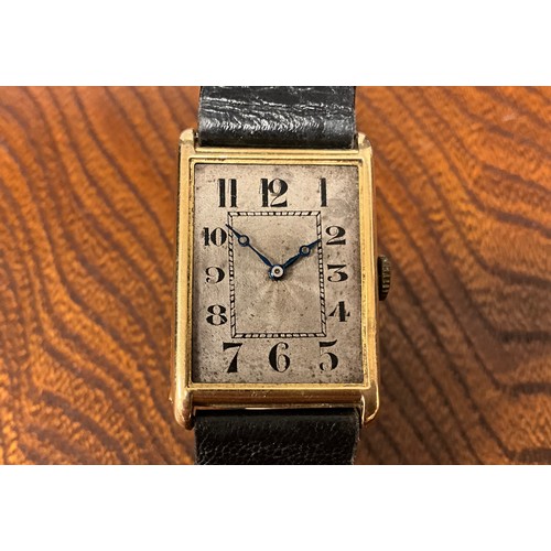 1045 - A 1920s gold cased wristwatch, rectangular silver dial, Arabic numerals, inner minute track, blued h... 