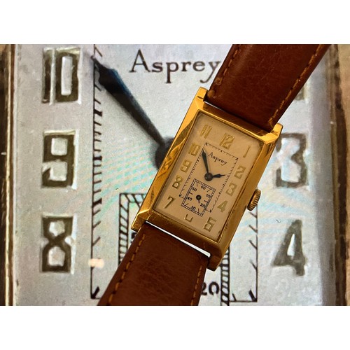 1098 - A 1920s Asprey 18ct gold tank cased wristwatch, textured silver dial, raised Arabic numerals, subsid... 