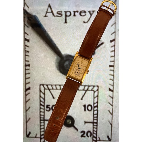 1098 - A 1920s Asprey 18ct gold tank cased wristwatch, textured silver dial, raised Arabic numerals, subsid... 