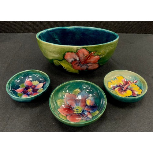 86 - Moorcroft including; oval ‘Hibiscus’ pattern bowl, 18cm wide, others, impressed marks (4)