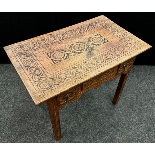 96 - A carved oak low boy / hall table, 70.5cm high x 85cm wide x 52.5cm deep, 20th century.