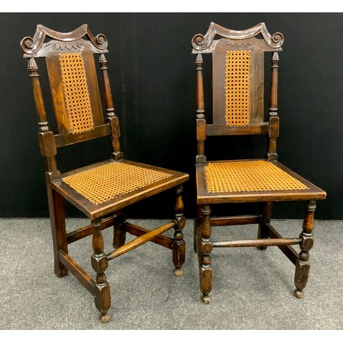 101 - A pair of Jacobean revival carved oak hall chairs, woven split-cane backs and seats, 97cm high x 44c... 