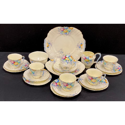 146 - A Crown Staffordshire tea set for six, decorated with multi coloured flowers, yellow ground, printed... 