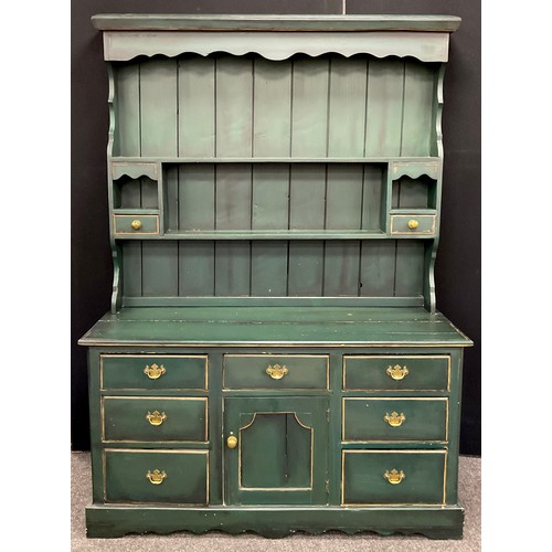 157 - A pine dresser, painted deep green, plate rack top with pair of small drawers, above a base with arr... 