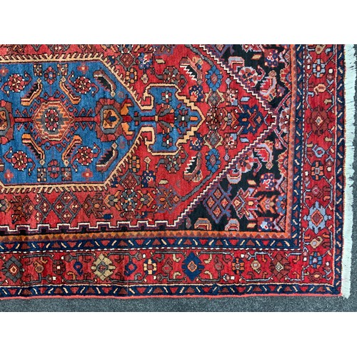 54 - A North West Persian Zanjan rug / carpet, hand-knotted in rich colour, with hexagonal shaped medalli... 