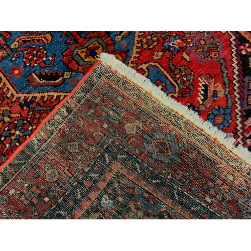 54 - A North West Persian Zanjan rug / carpet, hand-knotted in rich colour, with hexagonal shaped medalli... 