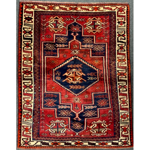 185 - A South West Persian Lori rug / carpet, hand-knotted with a central hexagonal medallion in deep blue... 