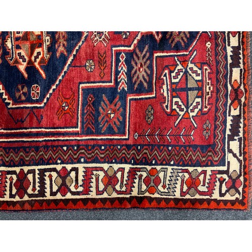 185 - A South West Persian Lori rug / carpet, hand-knotted with a central hexagonal medallion in deep blue... 