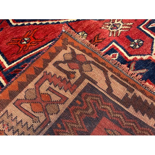 185 - A South West Persian Lori rug / carpet, hand-knotted with a central hexagonal medallion in deep blue... 