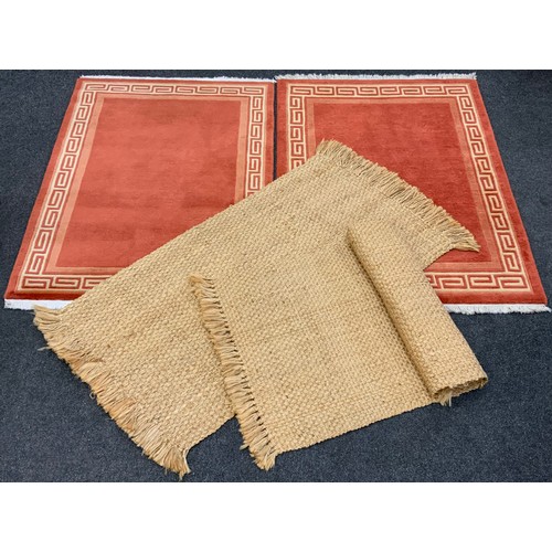 186 - A Pair of deep pile woolen rugs, with Greek key border design, each measuring approximately 179cm x ... 