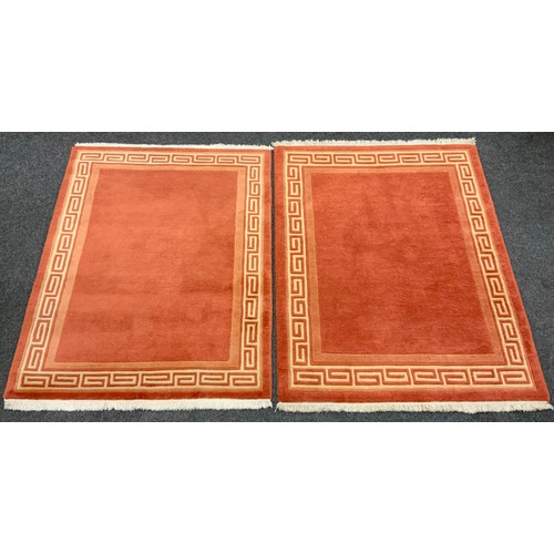 186 - A Pair of deep pile woolen rugs, with Greek key border design, each measuring approximately 179cm x ... 